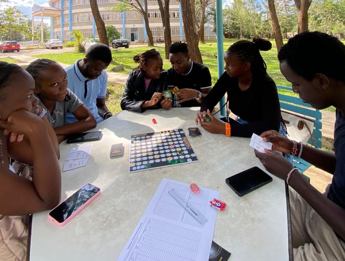 Students playing PesaMali Board Game